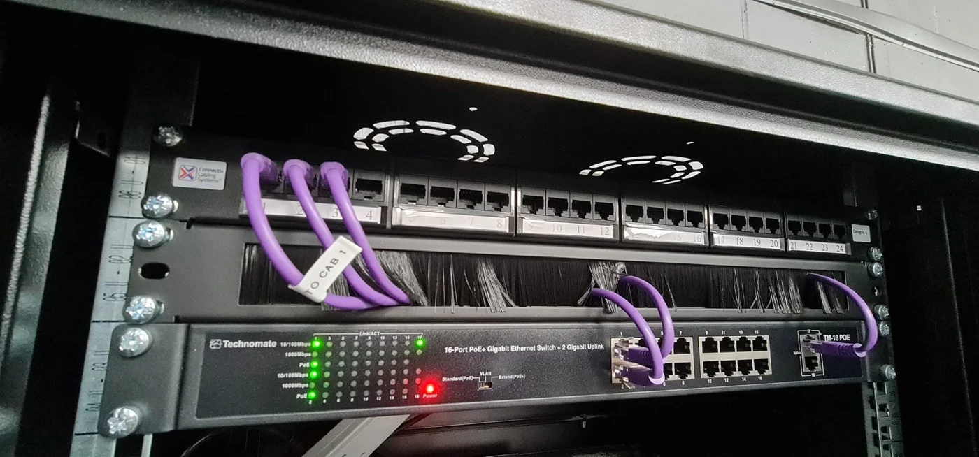 Network cabinet containing a patch panel and Ethernet switch
